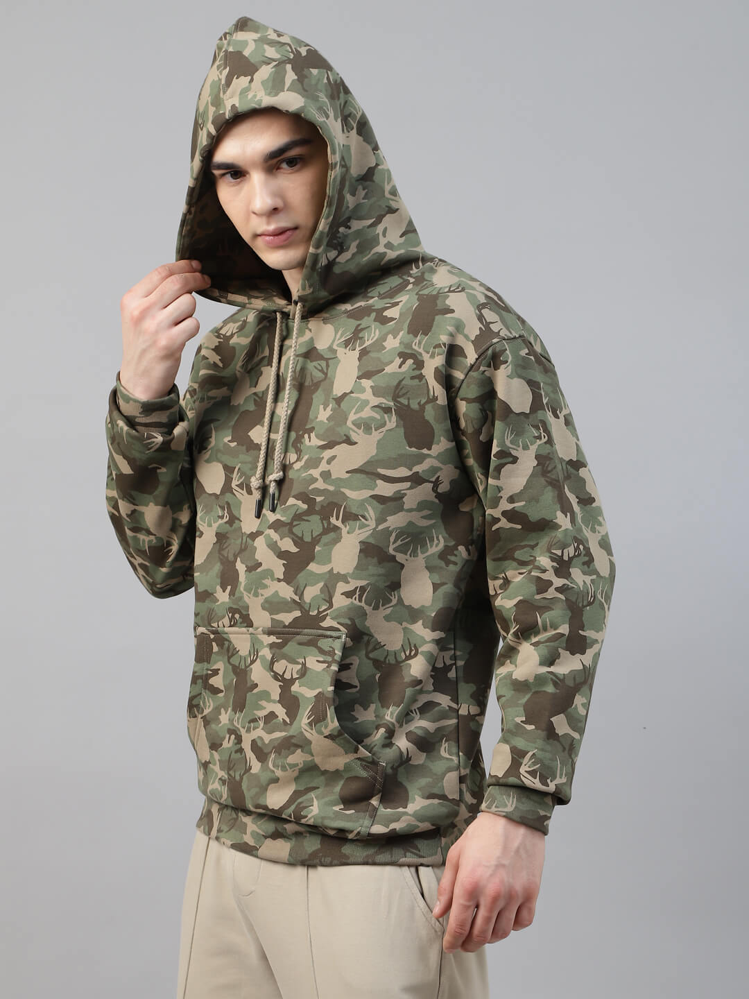 Person wearing a army print hoodie and cargo jogger