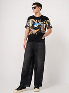 man wearing a thrust club's black cotton printed tshirt and jeans