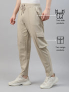Beige cargo pants with side and cargo pockets on a gray background