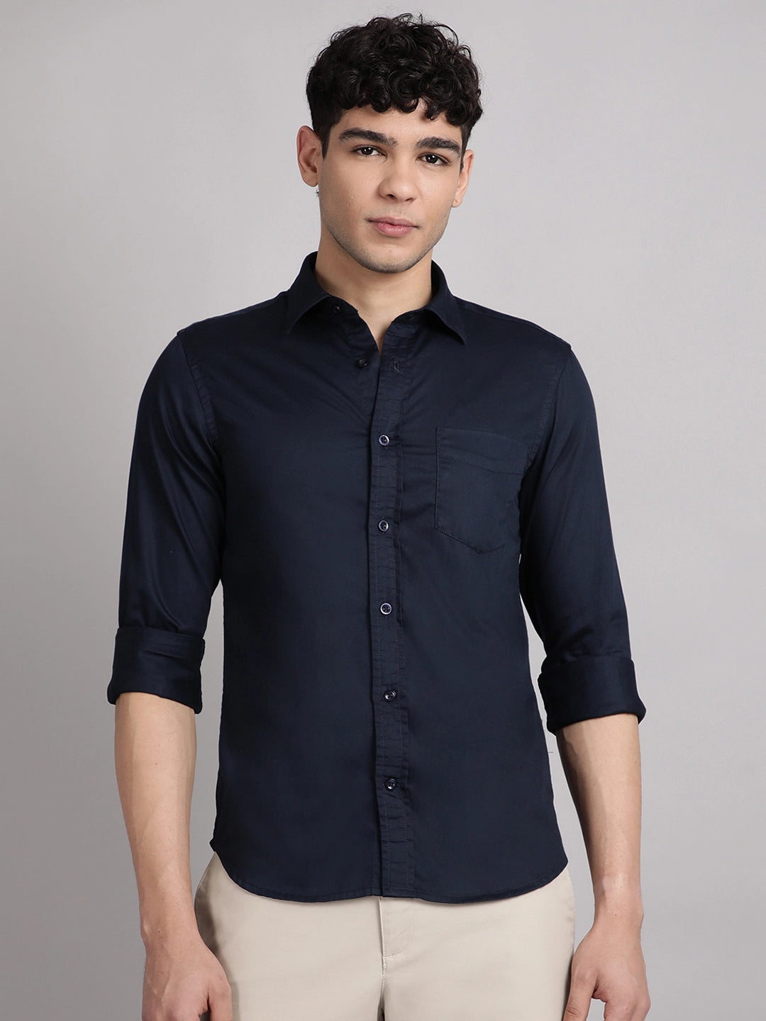 Man wearing a navy blue satin shirt
