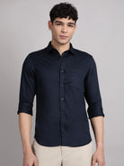 Man wearing a navy blue satin shirt