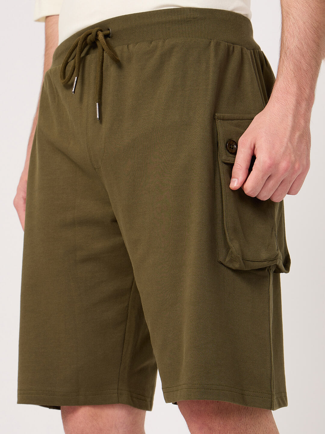Olive green cargo shorts with a pocket on a white background