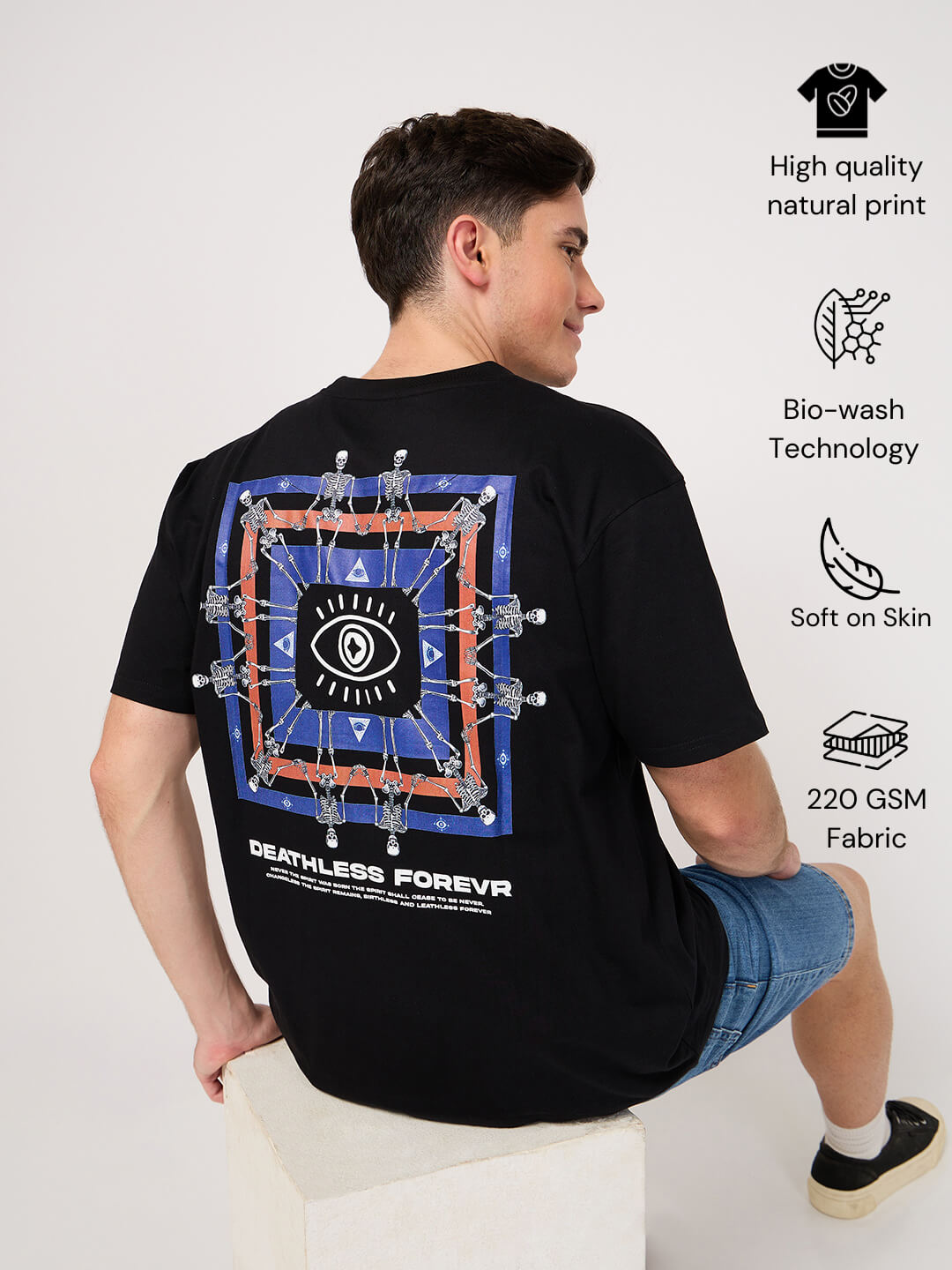 Person wearing a black t-shirt with a design on the back