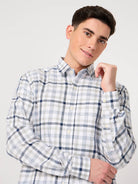 Man wearing a checkered shirt against a plain background